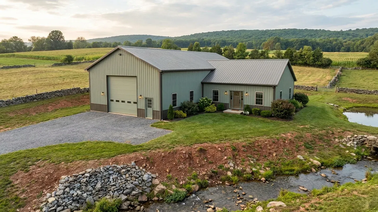 A barndominium with a tall, deep RV garage bay attached to the residence under one continuous roof.